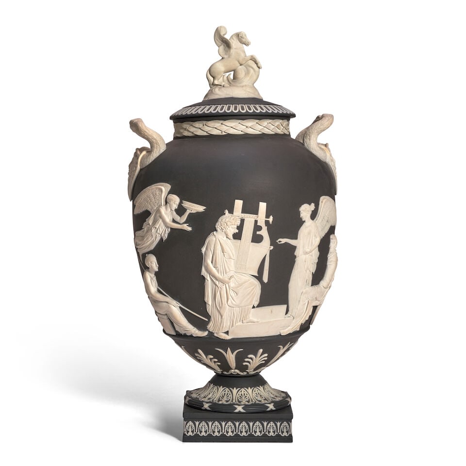 Wedgwood Bellows Black Jasper Dip Apotheosis Vase and Cover, England, 1911,: Wedgwood Bellows Black Jasper Dip Apotheosis Vase and Cover, England, 1911, made for Charles Bellows, applied white relief, the cover with Pegasus finial, the vase with Medusa mask and snake handles,