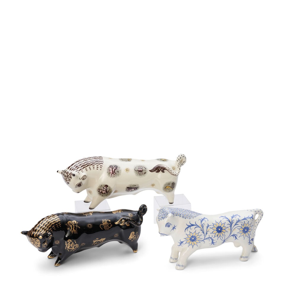 Three Wedgwood Arnold Machin Designed Bulls, England, c. 1960's,: Three Wedgwood Arnold Machin Designed Bulls, England, c. 1960's, a glazed black basalt Taurus with gilt printed zodiac motifs, lg. 14 1/4; a queen's ware Taurus with polychrome printed zodiac motifs,