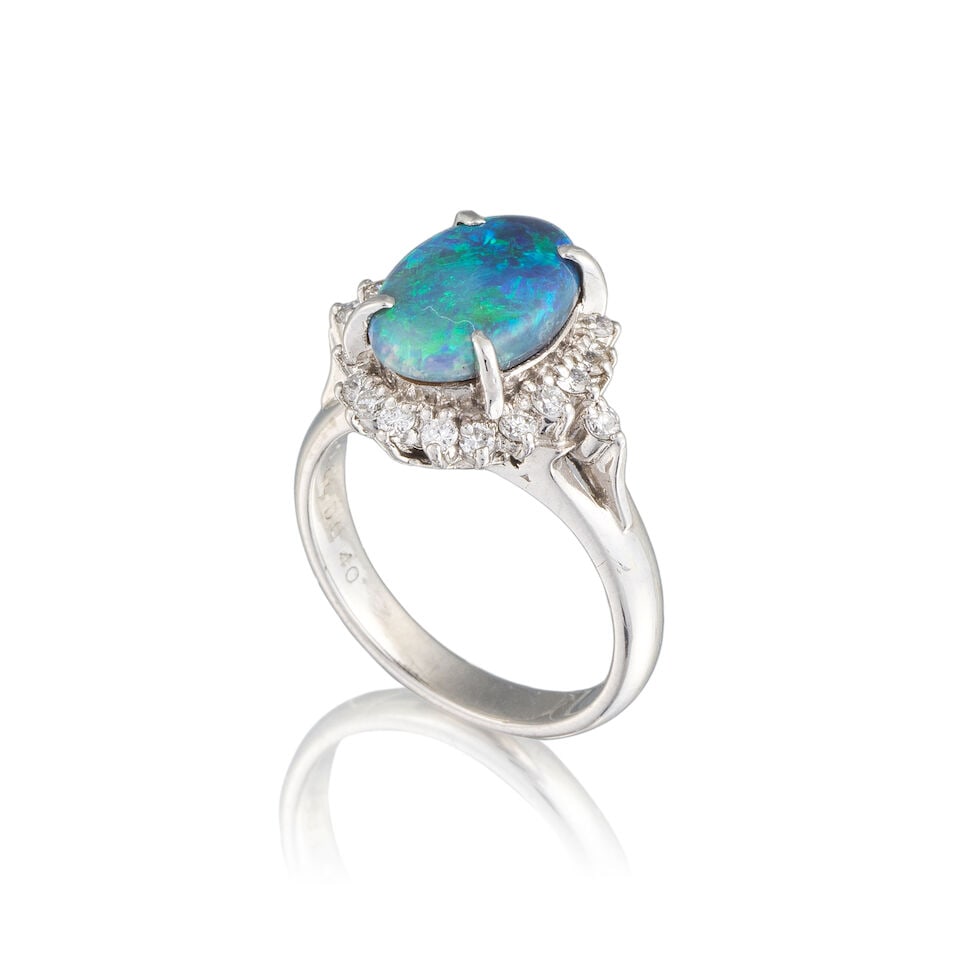 OPAL AND DIAMOND RING BAGUE OPALE DIAMANTS: OPAL AND DIAMOND RING BAGUE OPALE DIAMANTS • French import mark for platinum (850 ‰) • Cabochon opal weighing approximately 1.68 ct • 22 brilliant-cut diamonds weighing approxi