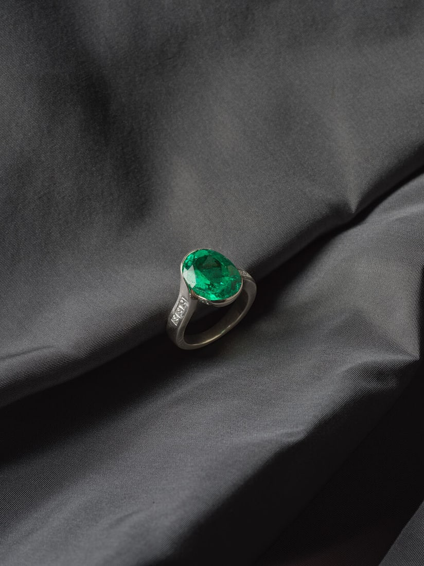 EMERALD AND DIAMOND RING BAGUE ÉMERAUDE ET DIAMANTS: EMERALD AND DIAMOND RING BAGUE ÉMERAUDE ET DIAMANTS • French import mark for 18 carat gold (750 ‰) • Oval-cut emerald weighing 5.84 carats • Numerous brilliant-cut and