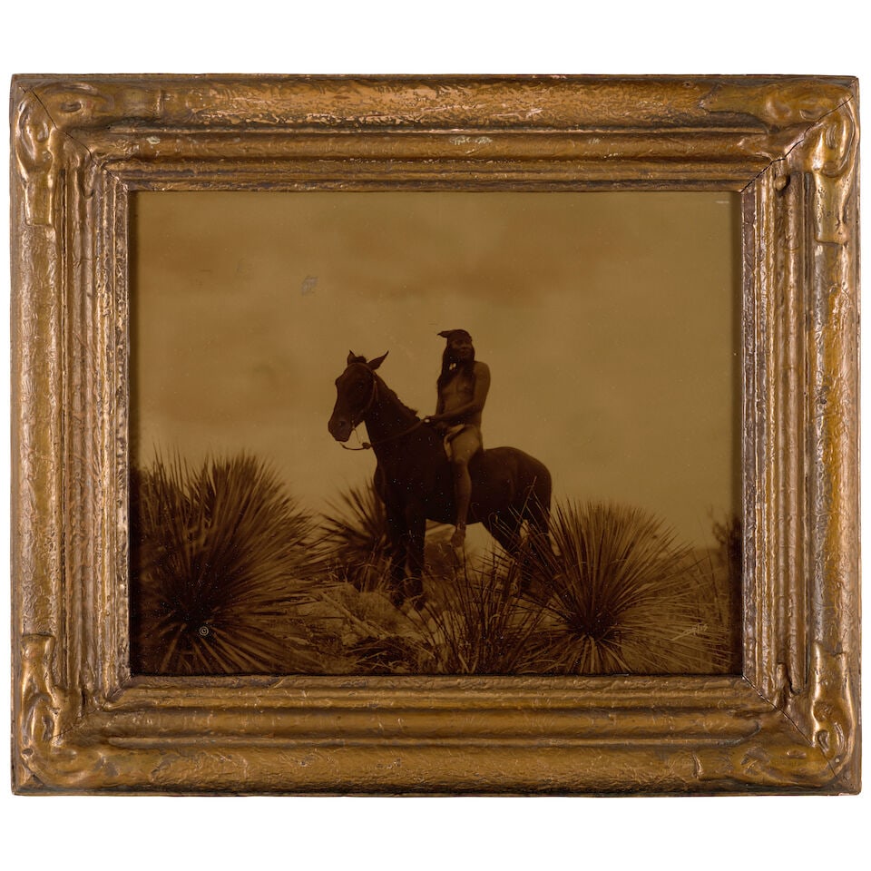 Edward S. Curtis (1868-1952); The Scout - Apache;: Edward S. Curtis (1868-1952) The Scout - Apache, 1906 Orotone, probably printed before 1920; signed and copyrighted in the negative, presented in its original Curtis Studio batwing-style frame. 7 5/8