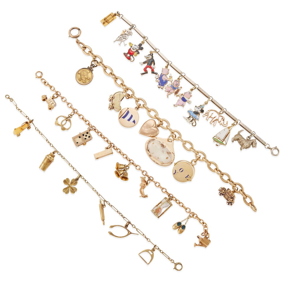 GROUP OF 4 CHARM BRACELETS: GROUP OF 4 CHARM BRACELETS • One bracelet of 14k yellow gold, suspending 7 charms total, 4 stamped for 14k yellow gold and 3 unstamped, 1 gold-plated, length 7 1/2 in. • One bracelet of 14
