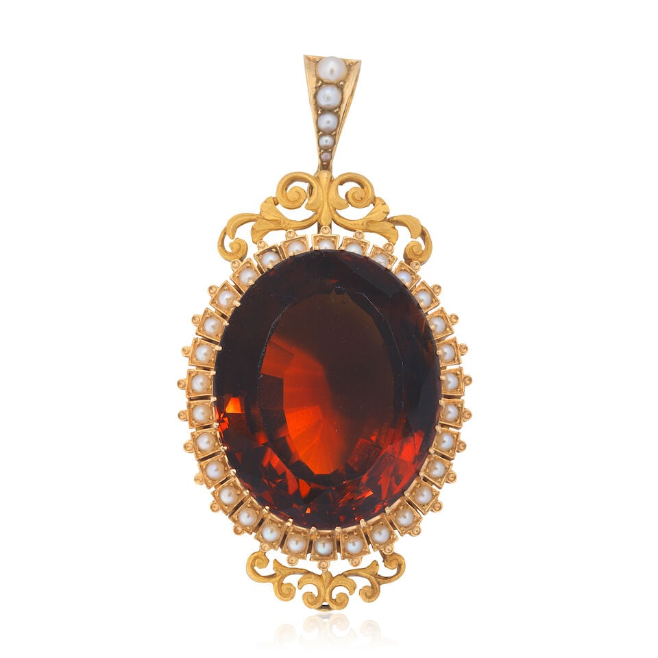 CITRINE AND SEED PEARL PENDANT: CITRINE AND SEED PEARL PENDANT Oval-cut citrine Seed pearls Length 6.1cm Weight approx. 31.5g Footnotes: OVERALL CONDITION Unhallmarked metal testing as 20kt gold. Loop for brooch fitting, pin