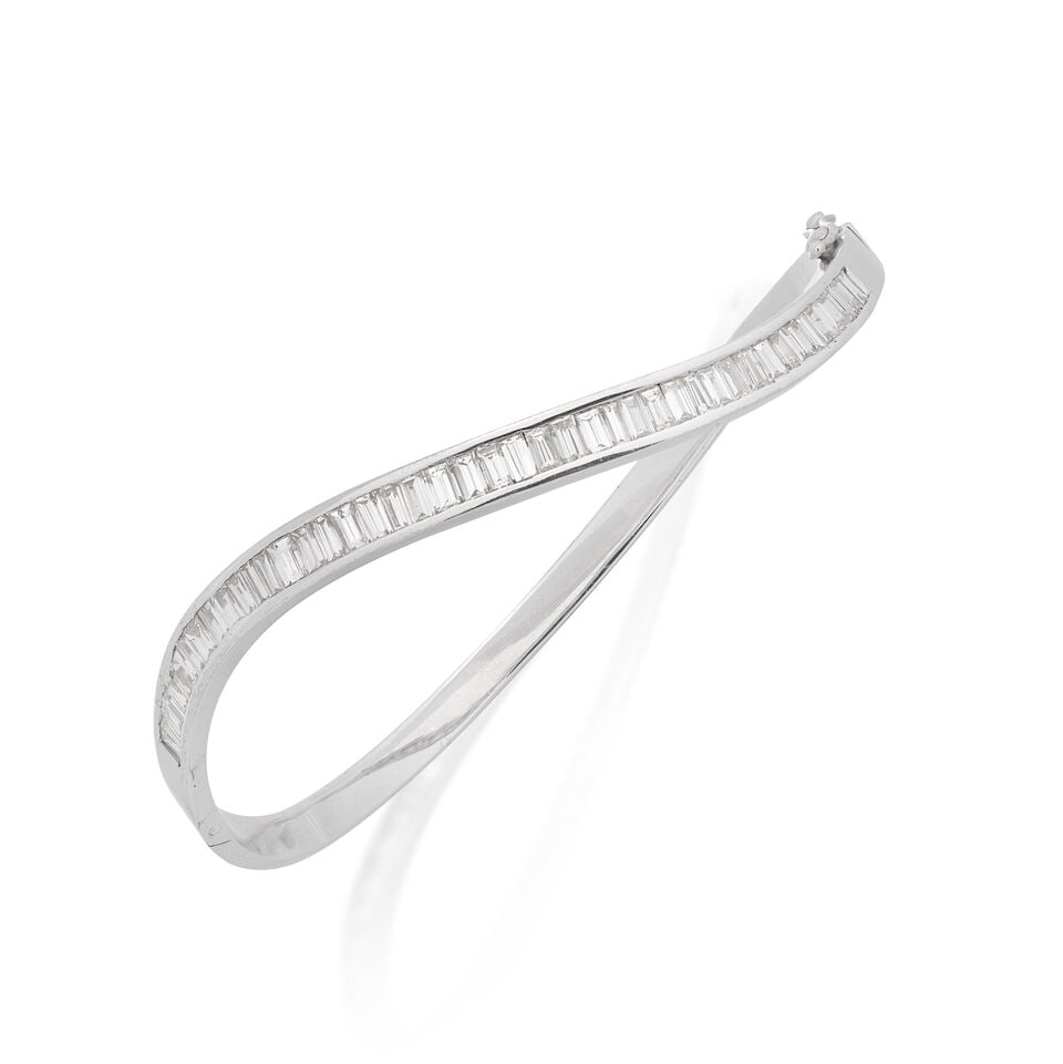 DIAMOND-SET BANGLE: DIAMOND-SET BANGLE Baguette-cut diamonds approx. 2.20cts total Inner circumference approx. 16.0cm Weight approx. 17.0g Footnotes: OVERALL CONDITION Light surface wear to unhallmarked metal stamped