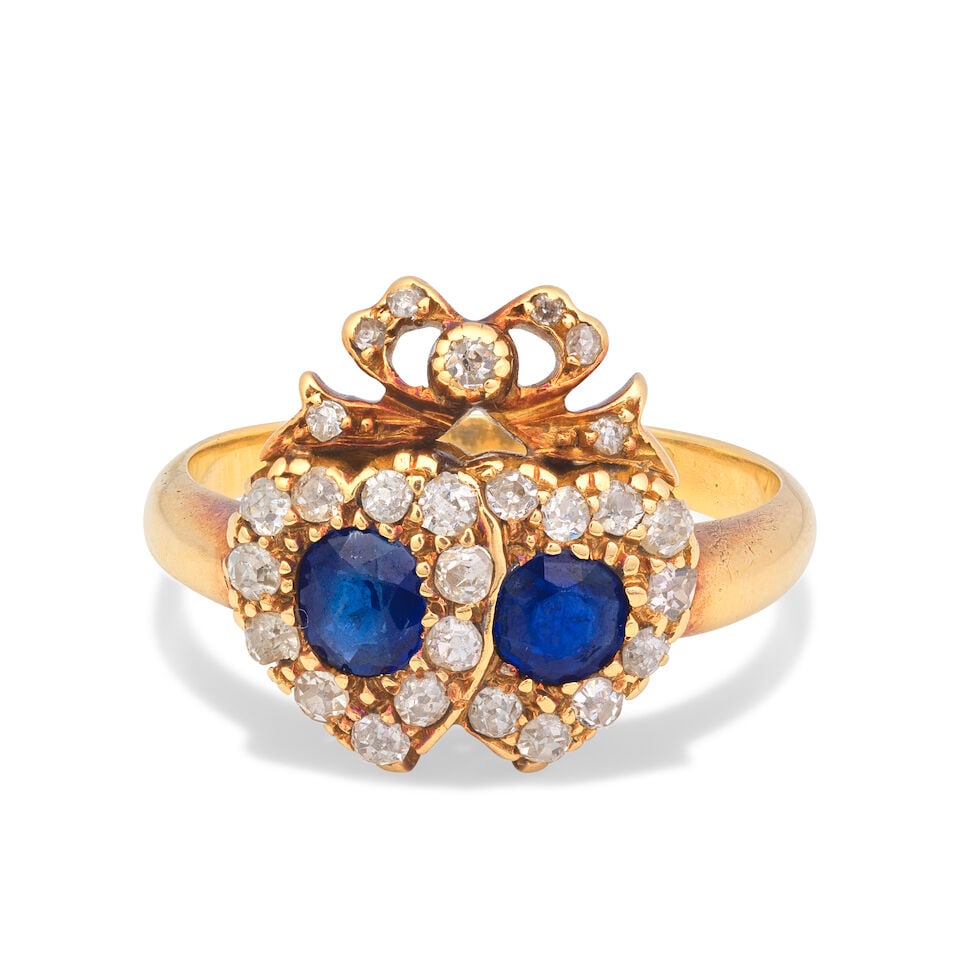 SAPPHIRE AND DIAMOND RING, CIRCA 1900: SAPPHIRE AND DIAMOND RING, CIRCA 1900 Of twin heart and bow design Oval and circular-cut sapphires Old single-cut diamonds Ring size approx. N Weight approx. 4.0g Footnotes: OVERALL CONDITION Light su