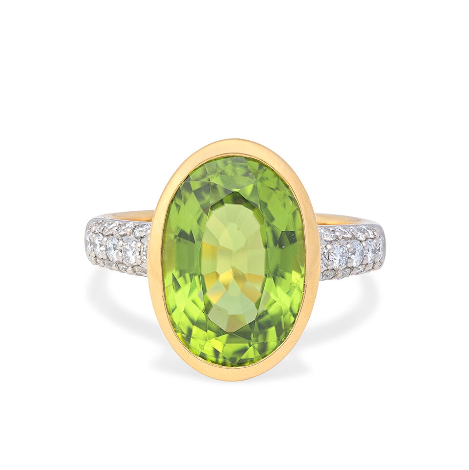 PERIDOT AND DIAMOND RING: PERIDOT AND DIAMOND RING Oval-cut peridot weighing 7.34 carats Brilliant-cut diamonds, approx. 0.40ct total Ring size approx. N½ Weight approx. 6.6g Footnotes: OVERALL CONDITION Negligible surfac