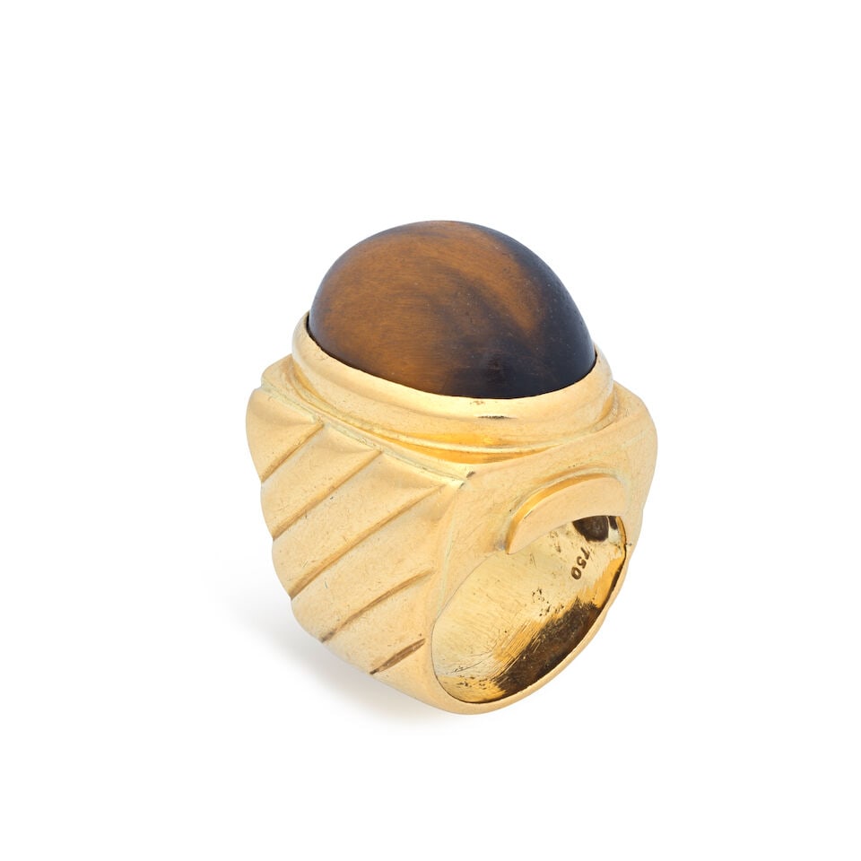 TIGER'S EYE RING: TIGER'S EYE RING Tiger's eye cabochon Ring size very approx. E (leading edge) Weight approx. 23.5g Footnotes: OVERALL CONDITION Surface wear to unhallmarked metal stamped to inner hoop with 750. TIGER