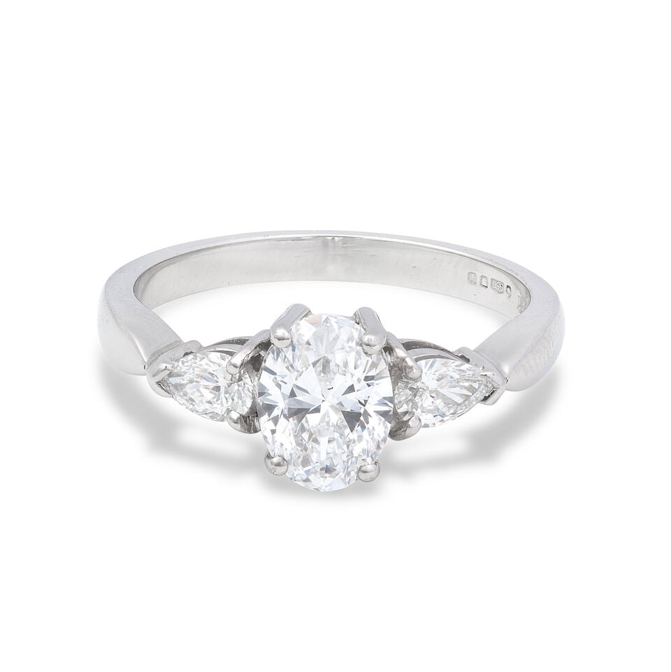 DIAMOND RING,: DIAMOND RING, 2008 Oval-cut diamond weighing 0.90 carat Pear-cut diamonds approx. 0.30ct total Platinum London hallmark Ring size approx. M Weight approx. 4.5g Footnotes: GIA Facsimile: 0.90 carat, D