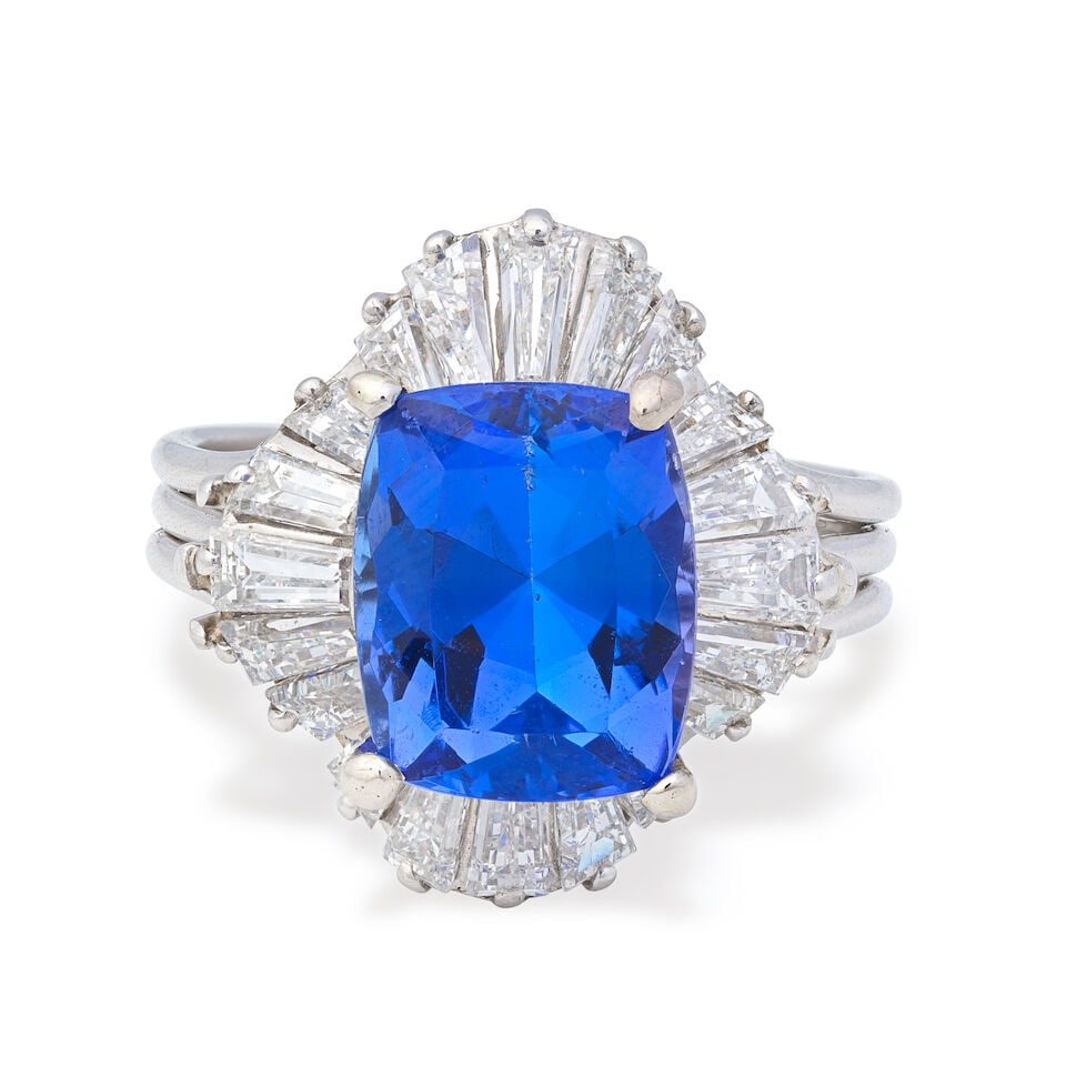 TANZANITE AND DIAMOND RING: TANZANITE AND DIAMOND RING Cushion-shaped tanzanite Tapered baguette-cut diamonds, approx. 1.00ct total Ring size approx. M Weight approx. 7.5g Footnotes: OVERALL CONDITION Light surface wear to unha