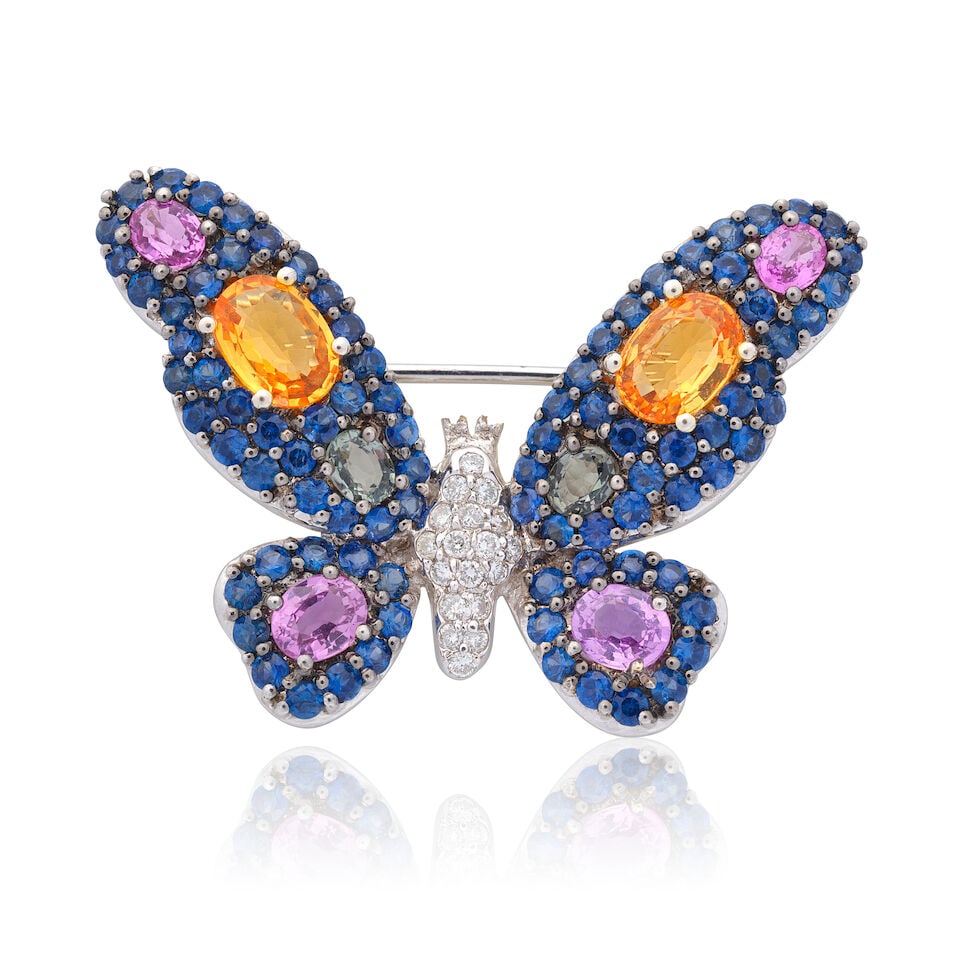 GEM AND DIAMOND-SET BUTTERFLY BROOCH/PENDANT: GEM AND DIAMOND-SET BUTTERFLY BROOCH/PENDANT Oval-cut vari-coloured quartz Oval-cut pink sapphires Circular-cut blue sapphires Brilliant-cut diamonds Width 3.9cm Length 2.7cm Weight approx. 9.0g Footn