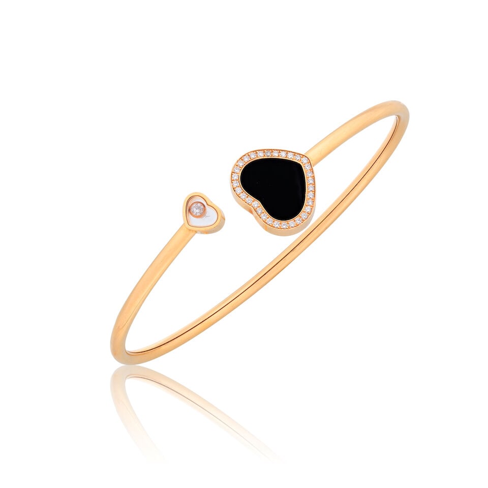 CHOPARD: 'HAPPY DIAMONDS' BANGLE: CHOPARD: 'HAPPY DIAMONDS' BANGLE Brilliant-cut diamonds weight approx. 0.35ct total Onyx 18 carat gold Signed Chopard, European convention mark, numbered 85A074, 6725743 Inner circumfrence approx. 17.
