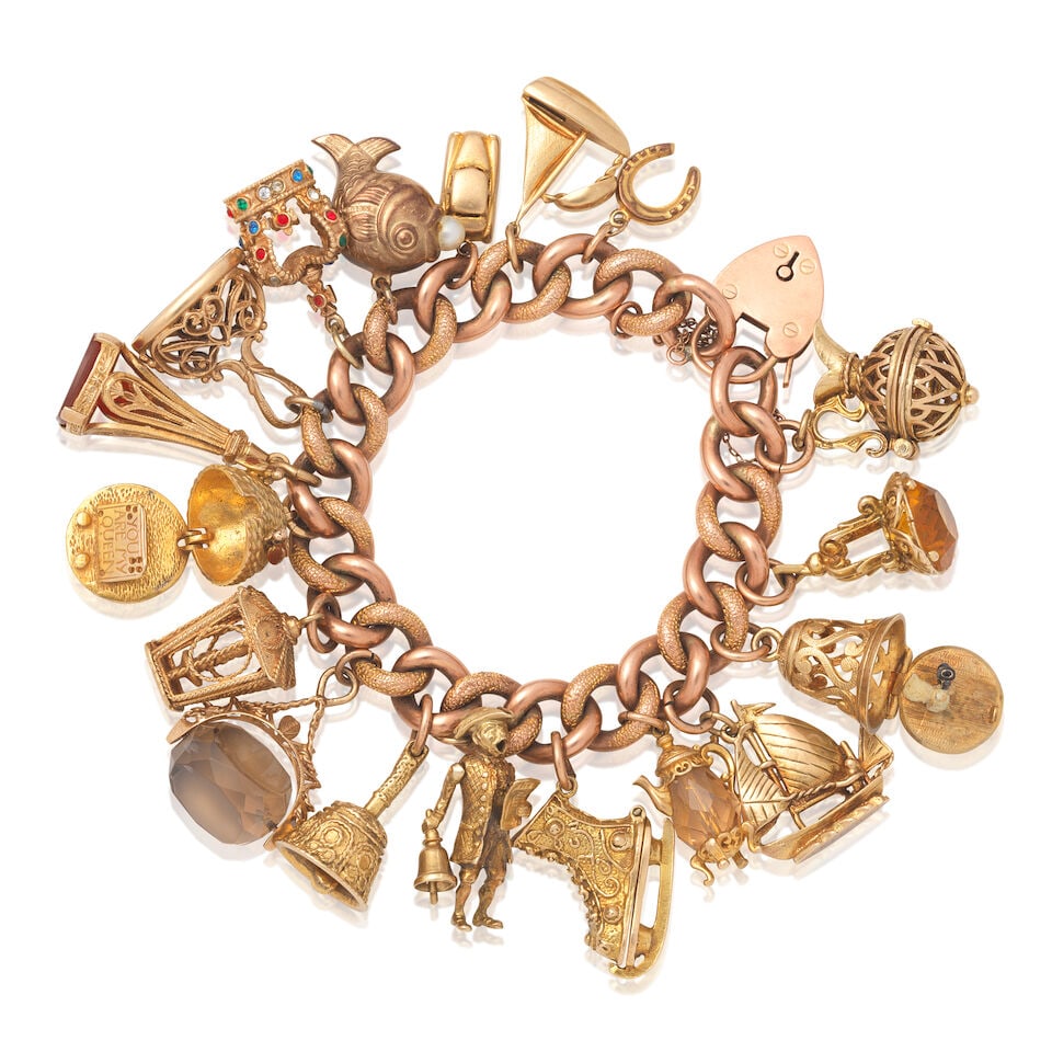 CHARM BRACELET: CHARM BRACELET Suspending eighteen charms including an ice skate, 'you are my queen' beehive, and articulated town crier. Inner circumference approx. 16.0cm Weight approx. 119.5g Footnotes: OVERALL