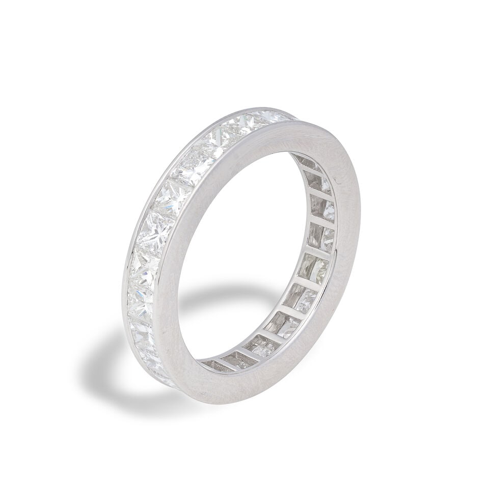 DIAMOND ETERNITY RING: DIAMOND ETERNITY RING Square-cut diamonds weighing 3.17 carats total Ring size approx. L½ Weight approx. 4.5g Footnotes: OVERALL CONDITION Negligible surface wear to unhallmarked metal testing