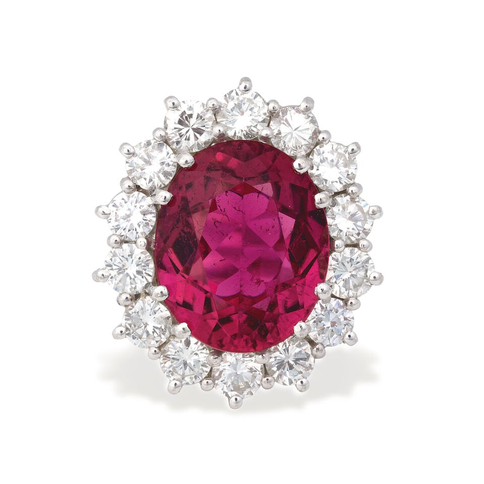 RUBELLITE TOURMALINE AND DIAMOND RING: RUBELLITE TOURMALINE AND DIAMOND RING Oval-cut rubellite tourmaline Brilliant-cut diamonds approx. 2.10cts total 18 carat gold London hallmark Ring size approx. M½ Weight approx.