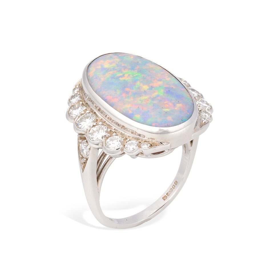 OPAL AND DIAMOND RING, 1984: OPAL AND DIAMOND RING, 1984 Opal cabochon Brilliant-cut diamonds approx. 0.60ct total 18 carat gold London hallmark Ring size approx. L Weight approx. 9.5g Footnotes: OVERALL CONDITION Light surface