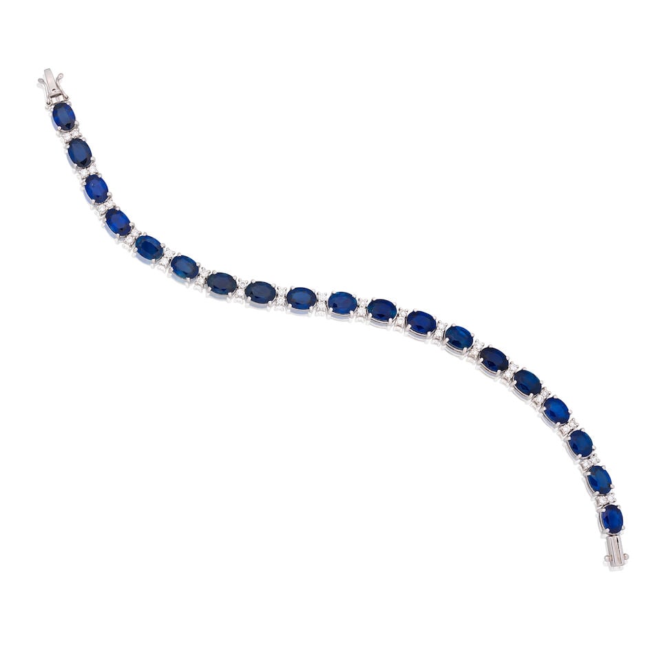 SAPPHIRE AND DIAMOND BRACELET: SAPPHIRE AND DIAMOND BRACELET Oval-cut sapphires Brilliant-cut diamonds approx. 0.70ct total Length 17.0cm Weight approx. 13.0g Footnotes: OVERALL CONDITION Light surface wear to unhallmarked metal