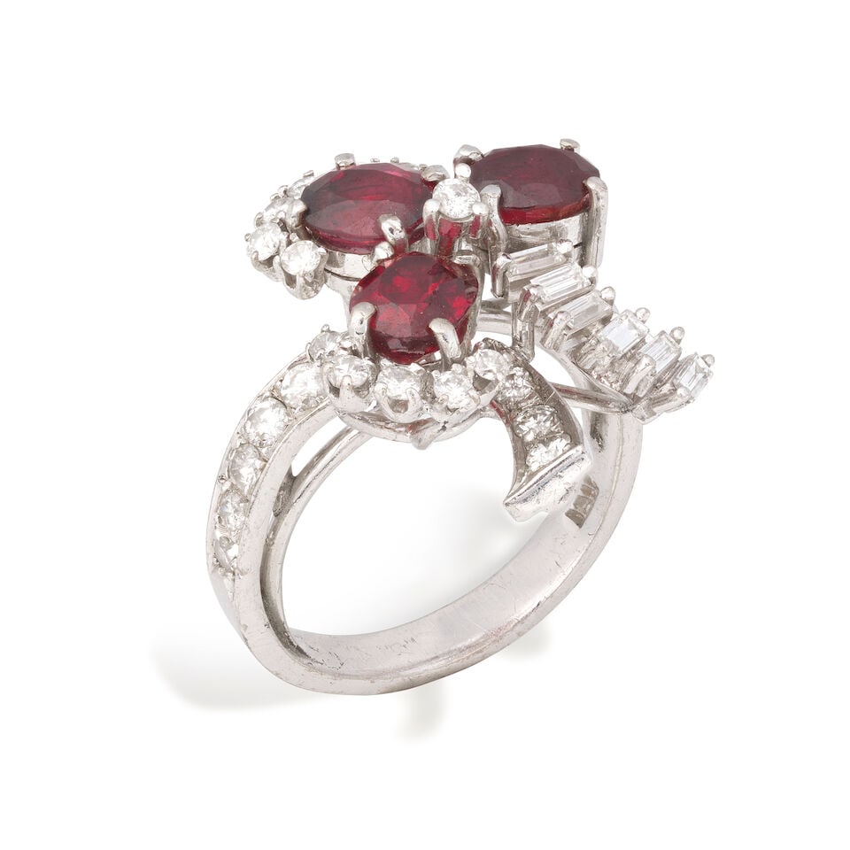 RUBY AND DIAMOND RING: RUBY AND DIAMOND RING Oval-cut rubies Brilliant and baguette-cut diamonds approx. 0.95ct total Ring size approx. N Weight approx. 7.5g Footnotes: OVERALL CONDITION Light surface wear to unhallmarked m