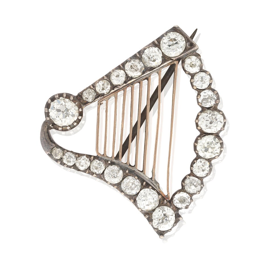DIAMOND-SET HARP BROOCH, CIRCA 1880: DIAMOND-SET HARP BROOCH, CIRCA 1880 Old oval, cushion and round brilliant-cut diamonds approx. 1.35cts total In closed back settings Length 2.5cm Weight approx. 4.0g Footnotes: OVERALL CONDITION Some 