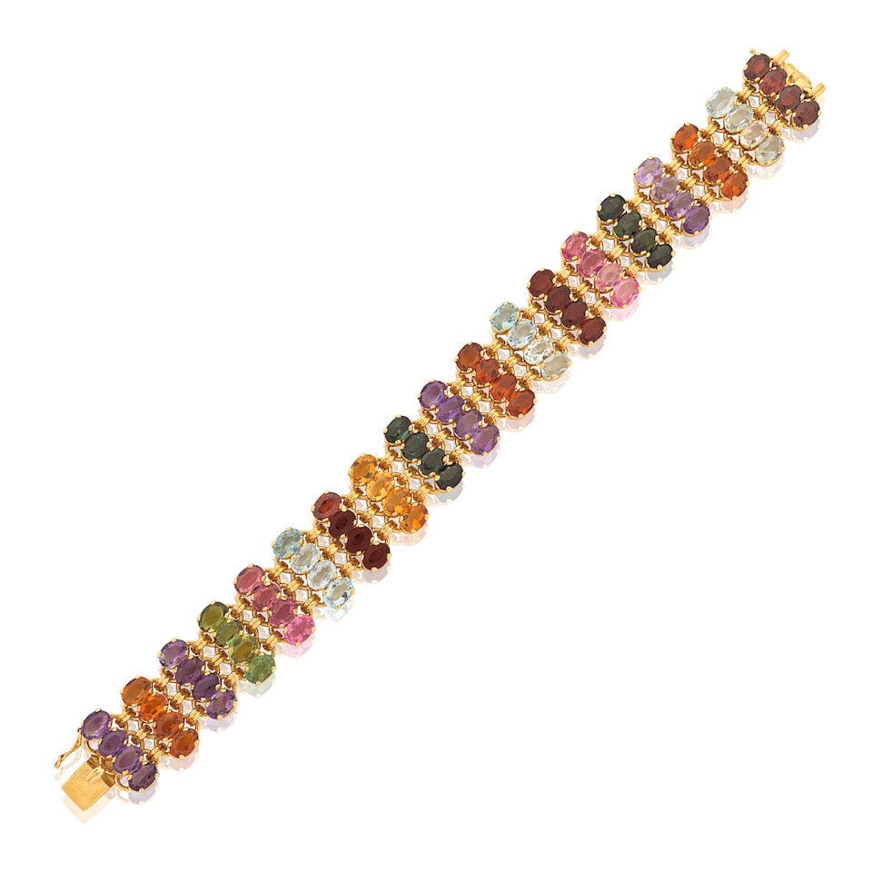 GEM-SET BRACELET: GEM-SET BRACELET Oval-cut gemstones including garnet, topaz, amethyst and quartz Length 19.0cm Weight approx. 43.0g Footnotes: OVERALL CONDITION Light surface wear to unhallmarked metal. Clasp stamped