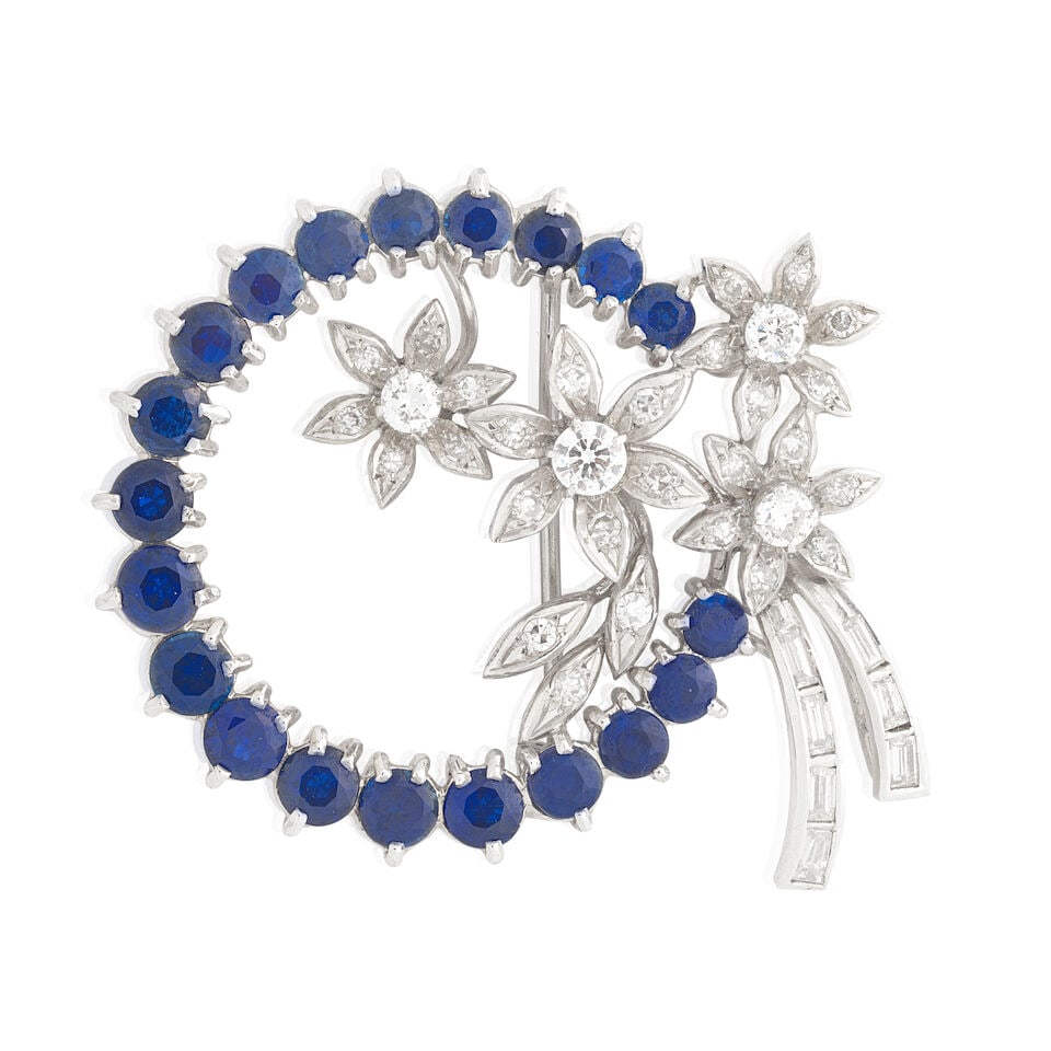 SAPPHIRE AND DIAMOND FLOWER BROOCH: SAPPHIRE AND DIAMOND FLOWER BROOCH Circular-cut sapphires Brilliant, single and tapered baguette-cut diamonds approx. 0.90ct total Length 4.0cm Weight approx. 10.0g Footnotes: OVERALL CONDITION Light