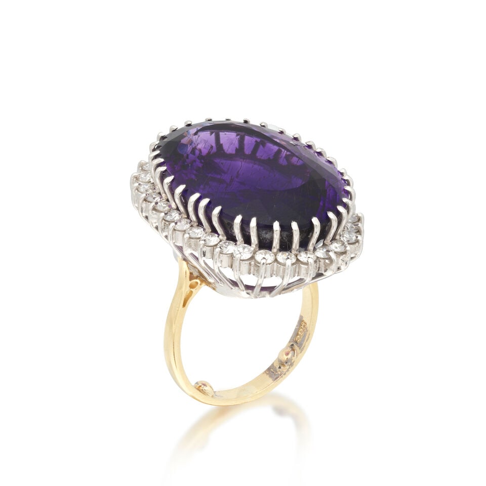 AMETHYST AND DIAMOND CLUSTER RING, 1982: AMETHYST AND DIAMOND CLUSTER RING, 1982 Oval-cut amethyst Brilliant-cut diamonds approx. 0.50ct total 18 carat gold London hallmark Ring size approx. K (sizing beads) Weight approx.