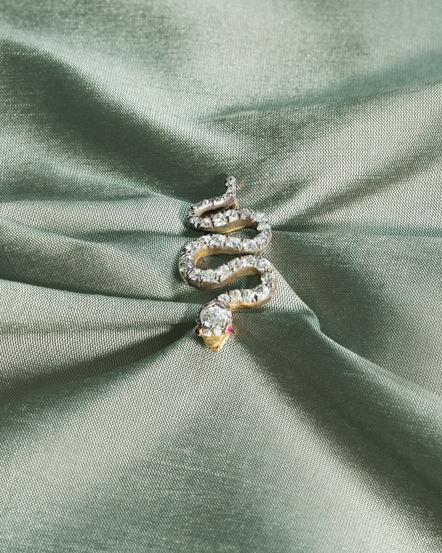 DIAMOND AND RUBY SERPENT BROOCH, CIRCA 1850: DIAMOND AND RUBY SERPENT BROOCH, CIRCA 1850 Old brilliant and single-cut diamonds approx. 1.30cts total Circular-cut rubies Mounted in silver and gold Length 3.8cm Weight approx. 5.0g Fitted