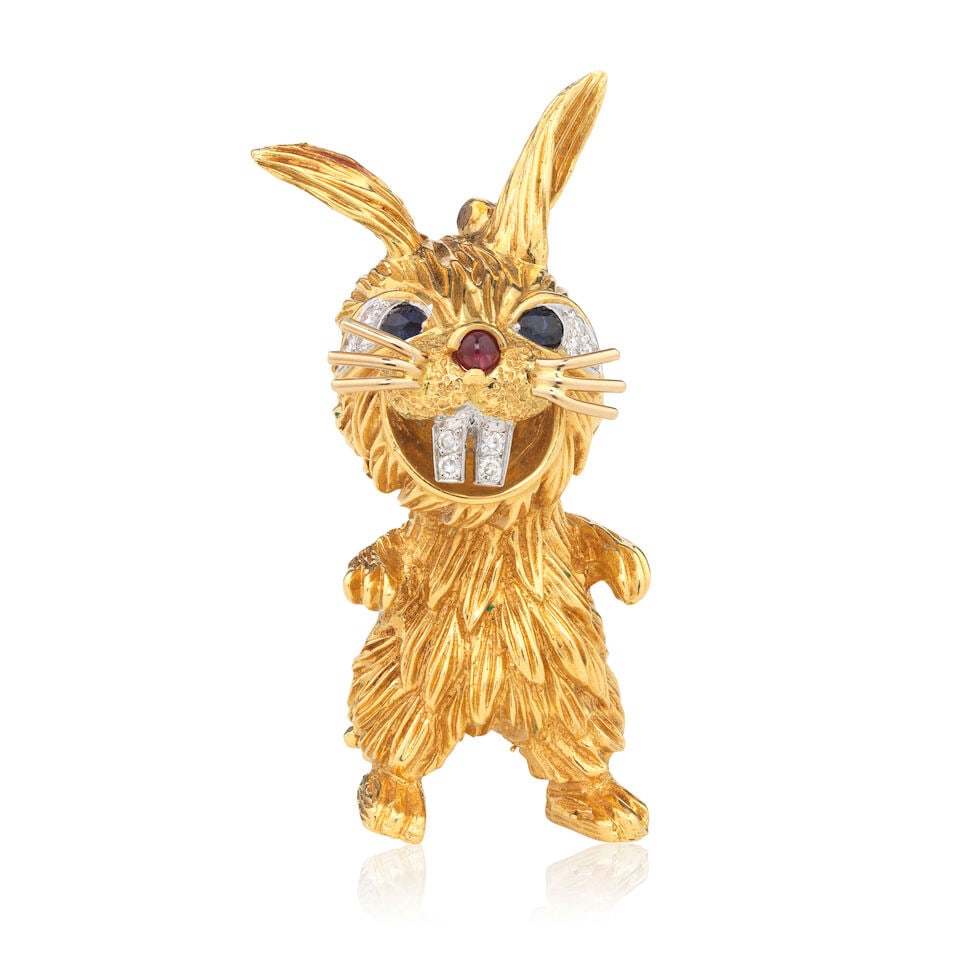 KUTCHINSKY: GEM-SET RABBIT BROOCH, 1975: KUTCHINSKY: GEM-SET RABBIT BROOCH, 1975 Single-cut diamonds Pear-cut sapphires Ruby cabochon 18 carat gold Signed Kutchinsky, London hallmark Length 5.0cm Weight approx. 29.0g Footnotes: OVERALL