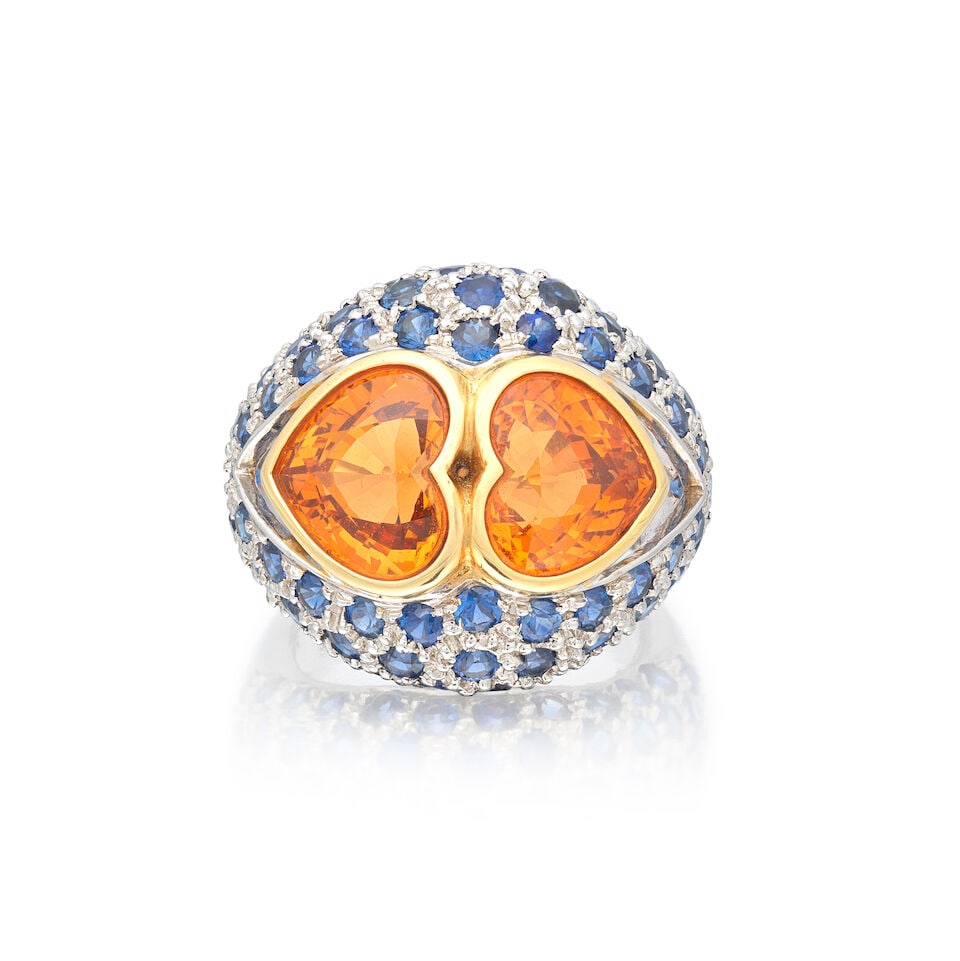 GARNET AND SAPPHIRE RING: GARNET AND SAPPHIRE RING Heart-shaped spessartine garnet Circular-cut sapphires Ring size approx. J½ Weight approx. 15.0g Footnotes: OVERALL CONDITION Light surface wear to unhallmarked white