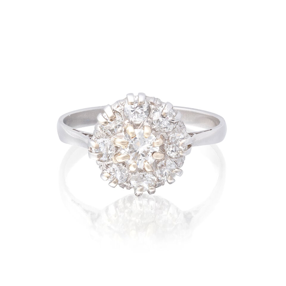 DIAMOND CLUSTER RING: DIAMOND CLUSTER RING Old brilliant-cut diamonds approx. 0.80cts total Ring size approx. N Weight approx. 3.5g Footnotes: OVERALL CONDITION Light surface wear to unhallmarked metal testing as
