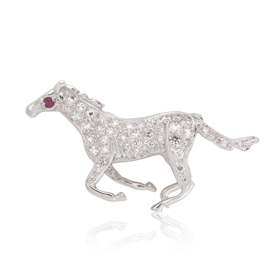 DIAMOND AND GEM-SET HORSE BROOCH, CIRCA 1969: DIAMOND AND GEM-SET HORSE BROOCH, CIRCA 1969 Single-cut diamonds approx. 0.35ct total Ruby cabochons 18 carat gold Dublin import mark Length 3.6cm Weight approx. 5.5g Footnotes: Please note that this
