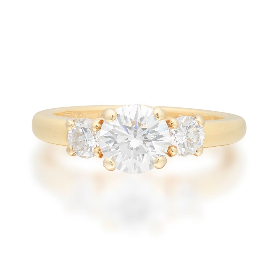 MOUNTED BY CARTIER: DIAMOND THREE-STONE RING, 1994: MOUNTED BY CARTIER: DIAMOND THREE-STONE RING, 1994 Brilliant-cut diamond 1.16 carats Brilliant-cut diamonds each weighing 0.26 carat 18 carat gold Signed Mtd. Cartier, numbered HLS00639, maker's mark 