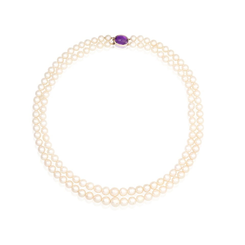 CULTURED PEARL NECKLACE: CULTURED PEARL NECKLACE Two strands of cultured pearls Amethyst cabochon Length of shortest strand 44.0cm Weight approx. 69.0g Footnotes: OVERALL CONDITION Light surface wear to unhallmarked metal