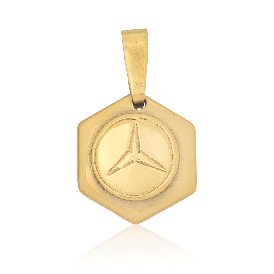 MERCEDES PENDANT: MERCEDES PENDANT Hexagonal shaped pendant with Mercedes logo Length 4.3cm Weight 14.0g Footnotes: OVERALL CONDITION Light wear to unhallmarked metal stamped to reverse with 585, 14K. This condition
