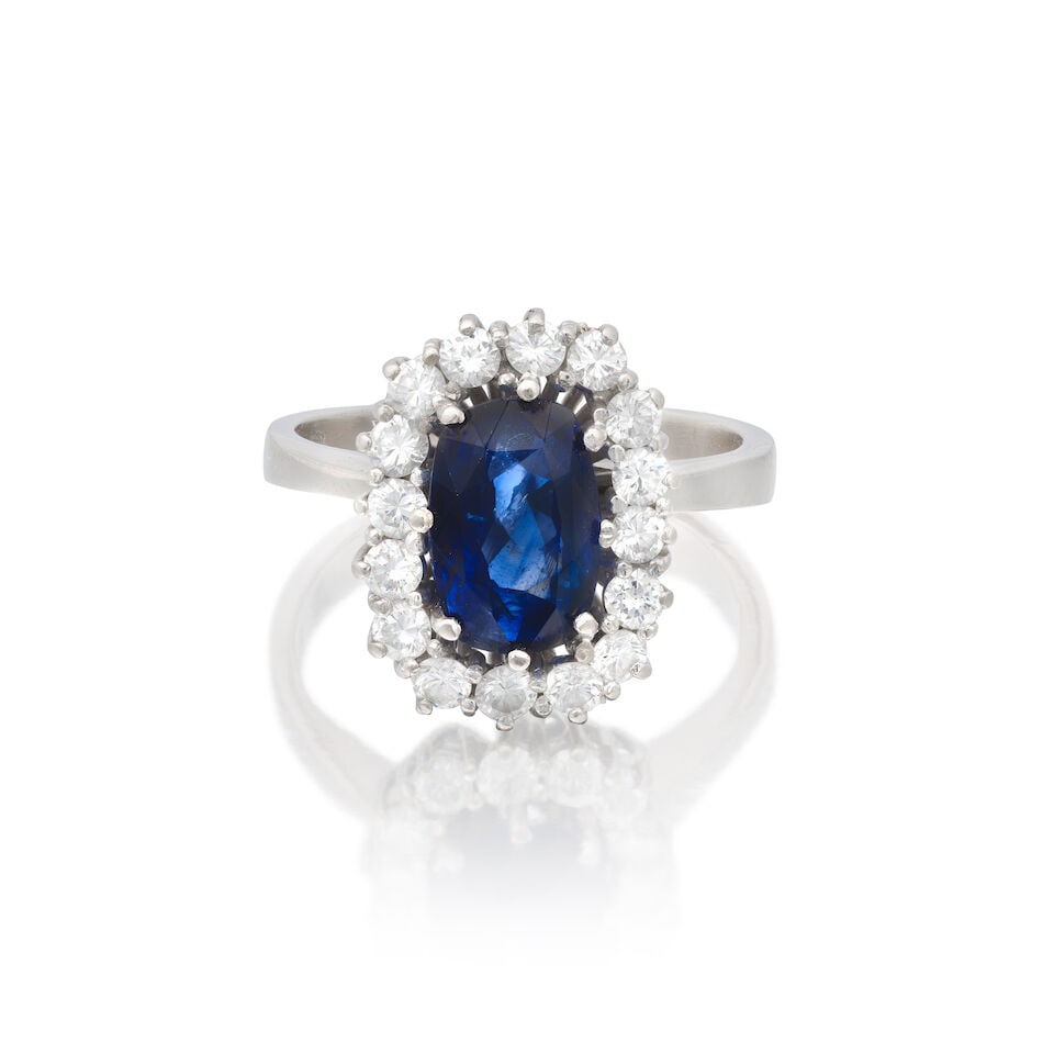 SAPPHIRE AND DIAMOND CLUSTER RING: SAPPHIRE AND DIAMOND CLUSTER RING Cushion-cut sapphire Brilliant-cut diamonds approx. 0.65ct total Ring size approx. L½ Weight approx. 6.0g Footnotes: OVERALL CONDITION Some surface wear to