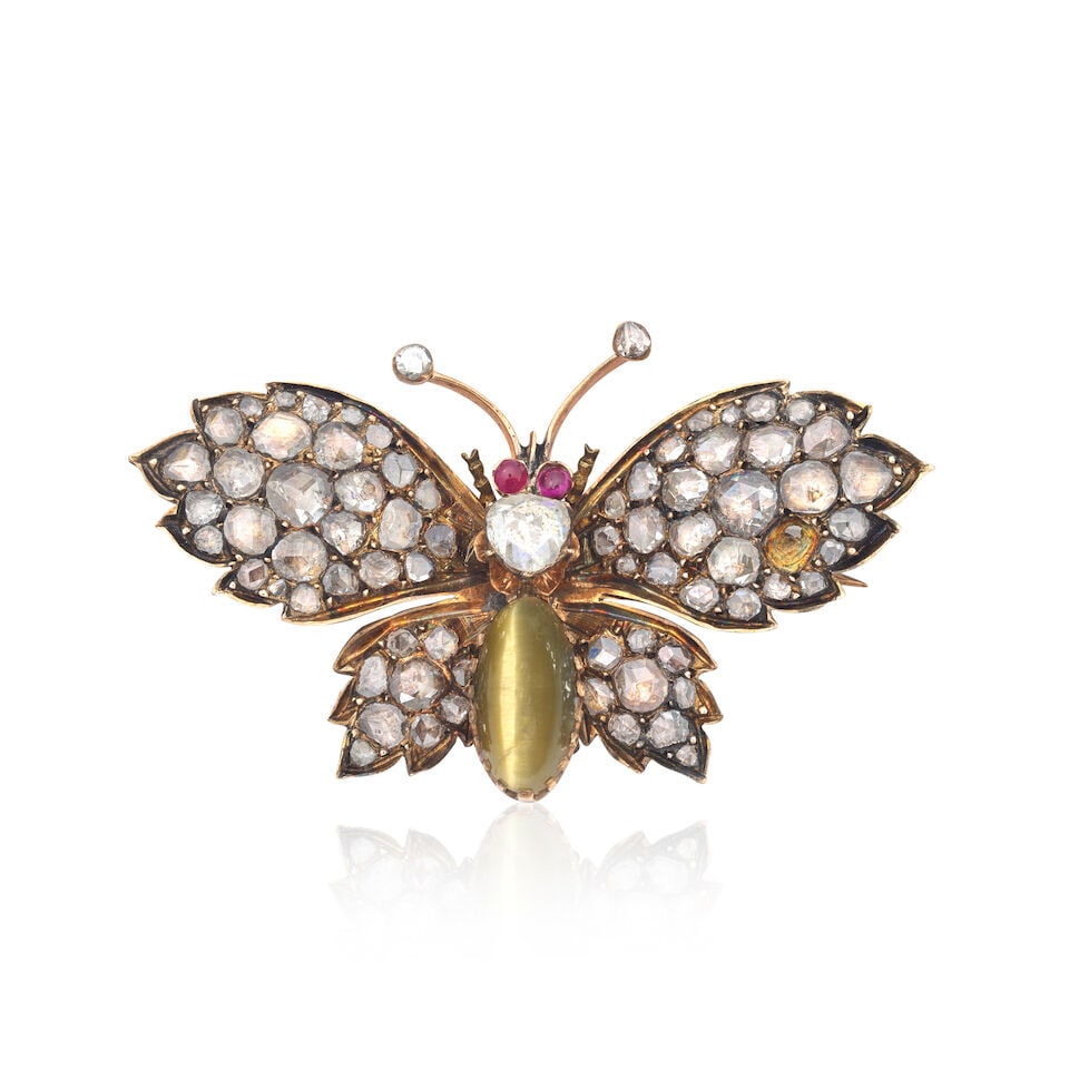 DIAMOND, CAT'S-EYE CHRYSOBERYL AND RUBY-SET BUTTERFLY BROOCH: DIAMOND, CAT'S-EYE CHRYSOBERYL AND RUBY-SET BUTTERFLY BROOCH Rose-cut diamonds Cat's-eye chrysoberyl cabochon Ruby cabochons Length 4.8cm Weight approx. 8.5g Footnotes: OVERALL CONDITION Visible wear