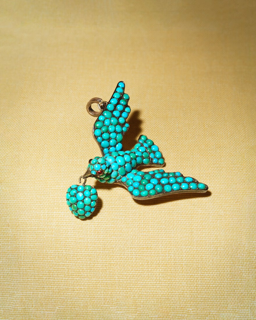 TURQUOISE-SET SAINT ESPIRIT BIRD PENDANT, CIRCA 1860: TURQUOISE-SET SAINT ESPIRIT BIRD PENDANT, CIRCA 1860 Turquoise cabochons Red paste cabochon-set eyes Glazed compartment to reverse of heart Mounted in silver and gold Length 5.0cm Weight approx. 16.0g