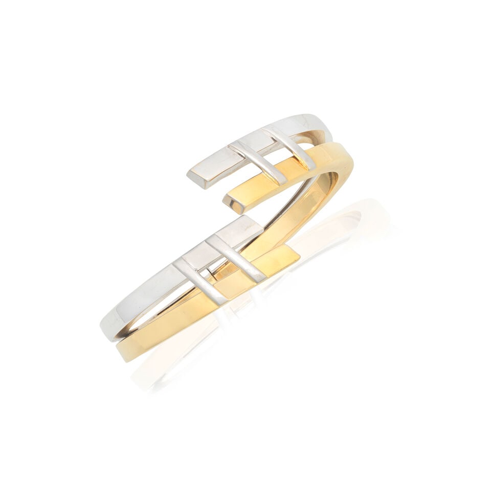 AURITALIA: BI-COLOURED BANGLE: AURITALIA: BI-COLOURED BANGLE Of hinged design Signed Auritalia Inner circumference 16.0cm Weight approx. 44.5g Footnotes: OVERALL CONDITION Some light wear to unhallmarked bi-coloured metal, some