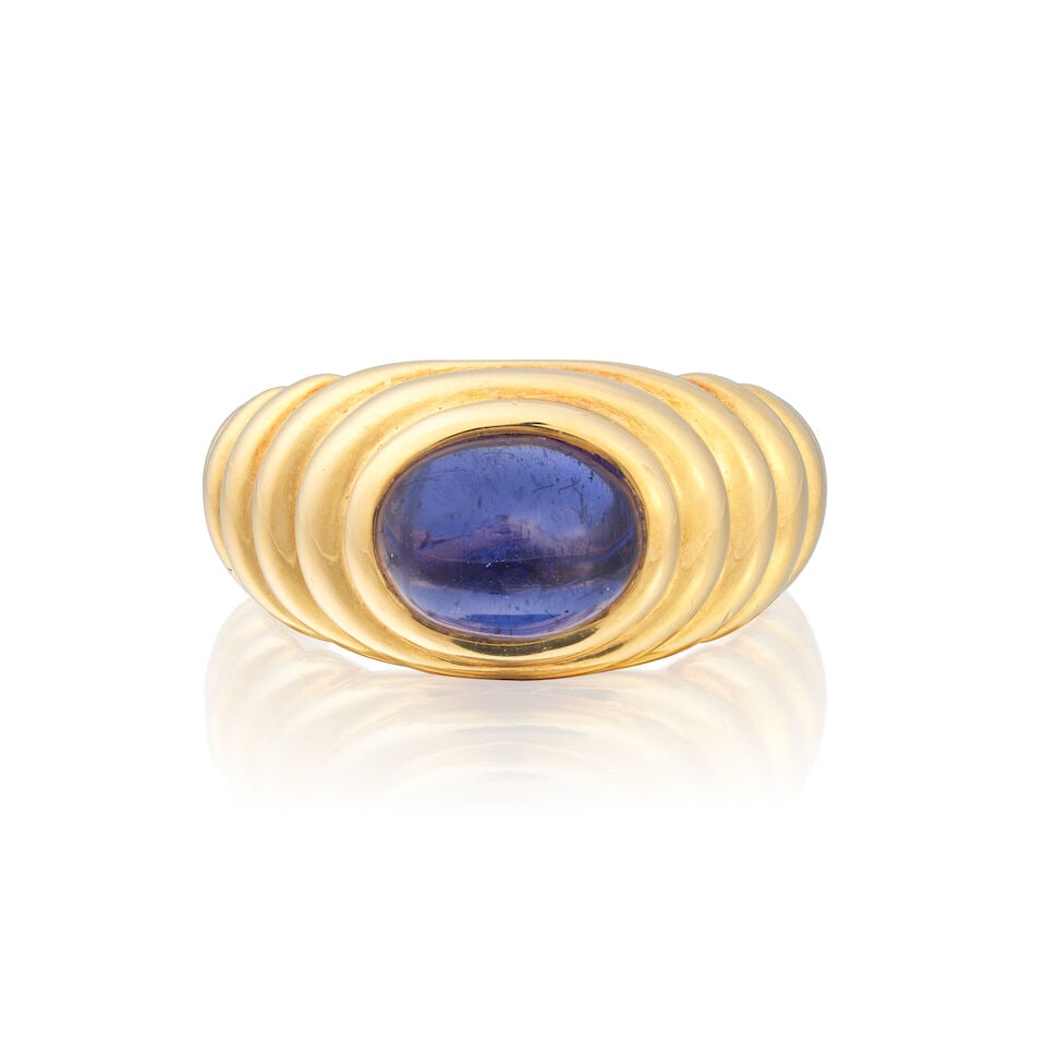 BULGARI: IOLITE 'BACCELLATO' RING, 2001: BULGARI: IOLITE 'BACCELLATO' RING, 2001 Iolite cabochon 18 carat gold Signed Bulgari, maker's mark SB, London hallmark Ring size approx. K Weight approx. 8.5g Footnotes: OVERALL CONDITION Very light
