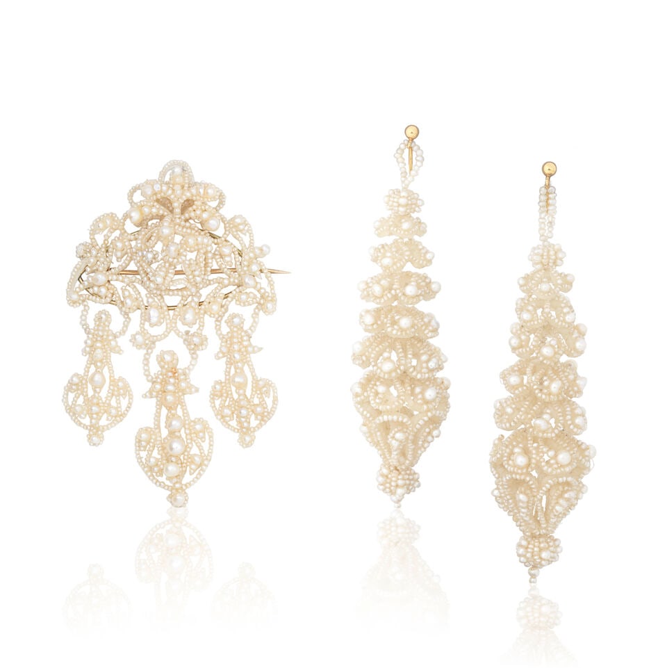 SEED PEARL AND MOTHER-OF-PEARL BROOCH AND EARRING SUITE, CIRCA MID-19TH CENTURY: SEED PEARL AND MOTHER-OF-PEARL BROOCH AND EARRING SUITE, CIRCA MID-19TH CENTURY Seed pearls Mother-of-pearl structure Earring length 8.5cm, brooch length 8.0cm Weight approx. 28.0g Footnotes: Please n