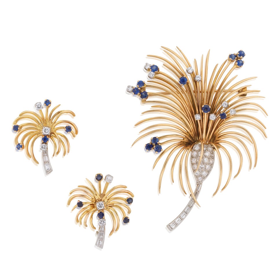 DIAMOND AND SAPPHIRE FLOWER BROOCH AND EARRING SUITE: DIAMOND AND SAPPHIRE FLOWER BROOCH AND EARRING SUITE Circular-cut sapphires Brilliant and baguette-cut diamonds approx. 1.50cts total Length 6.5cm Weight approx. 36.0g Footnotes: OVERALL