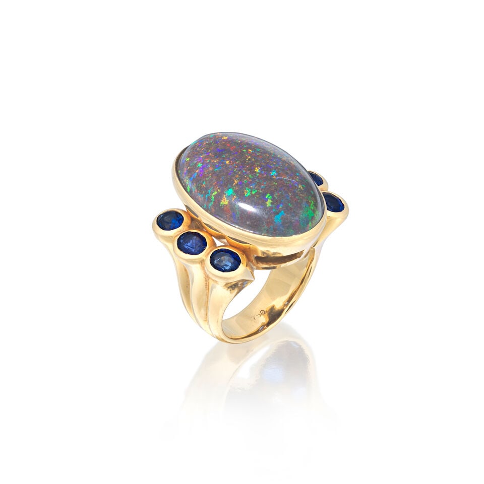 OPAL AND SAPPHIRE DRESS RING: OPAL AND SAPPHIRE DRESS RING Black opal cabochon Circular-cut sapphires Ring size approx. K (leading edge) Weight approx. 19.0g Footnotes: OVERALL CONDITION Light wear, scratches to hoop commensurate