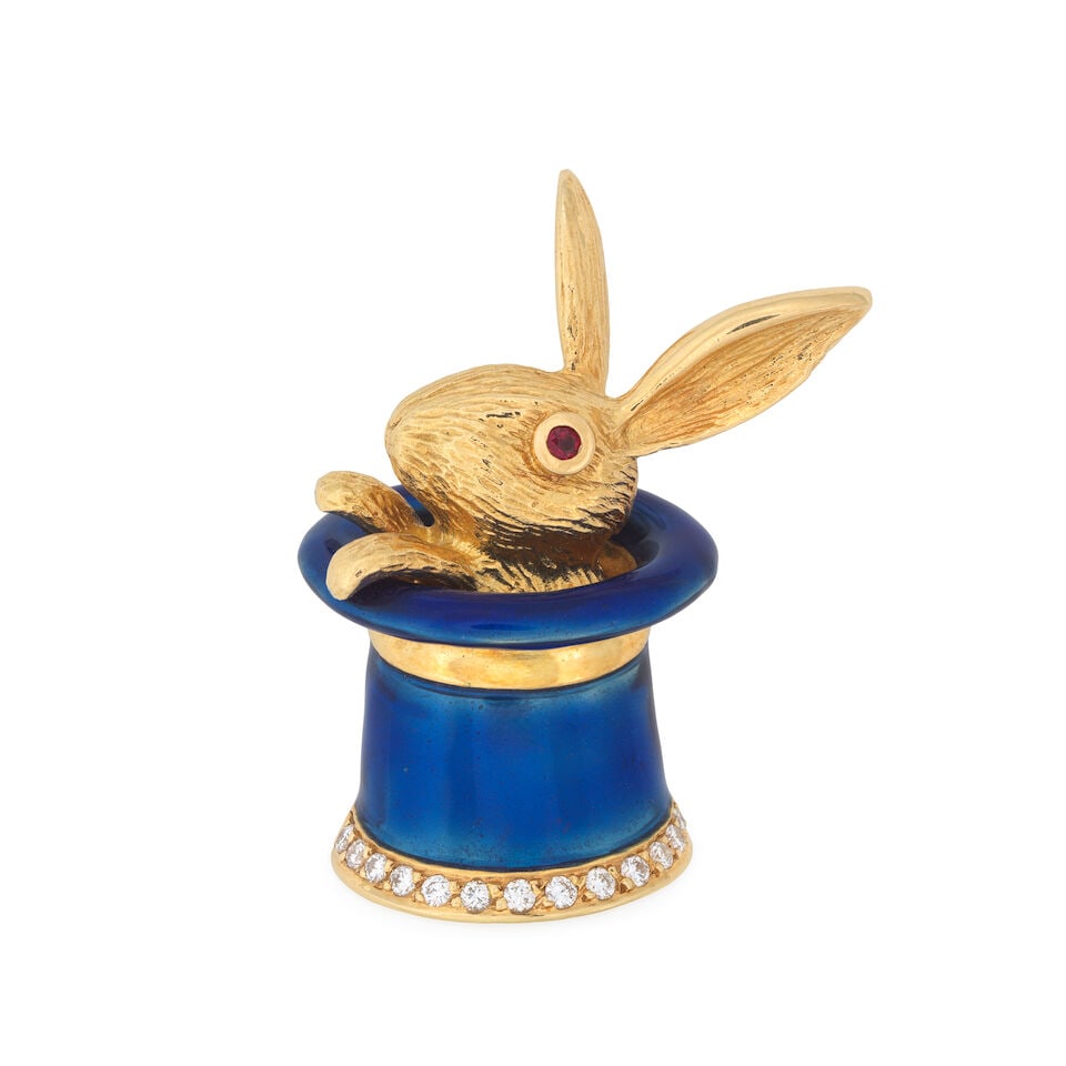 ENAMEL AND GEM-SET 'RABBIT IN A HAT' BROOCH/PENDANT: ENAMEL AND GEM-SET 'RABBIT IN A HAT' BROOCH/PENDANT Brilliant-cut diamonds Circular-cut rubies Blue enamel French assay marks Length 3.0cm Weight approx. 12.0g Footnotes: OVERALL CONDITION Light surfa