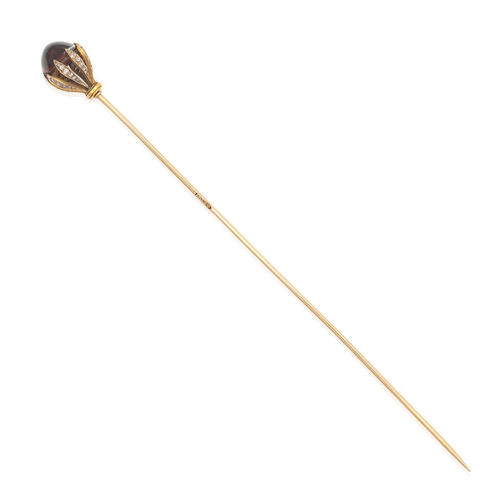 GARNET AND DIAMOND HAT PIN, CIRCA 1895: GARNET AND DIAMOND HAT PIN, CIRCA 1895 Garnet cabochon Rose-cut diamonds Workmaster's mark A.W Russian assay mark Mounted in gold Length 15.7cm Footnotes: A Private Family Legacy This lot is part of