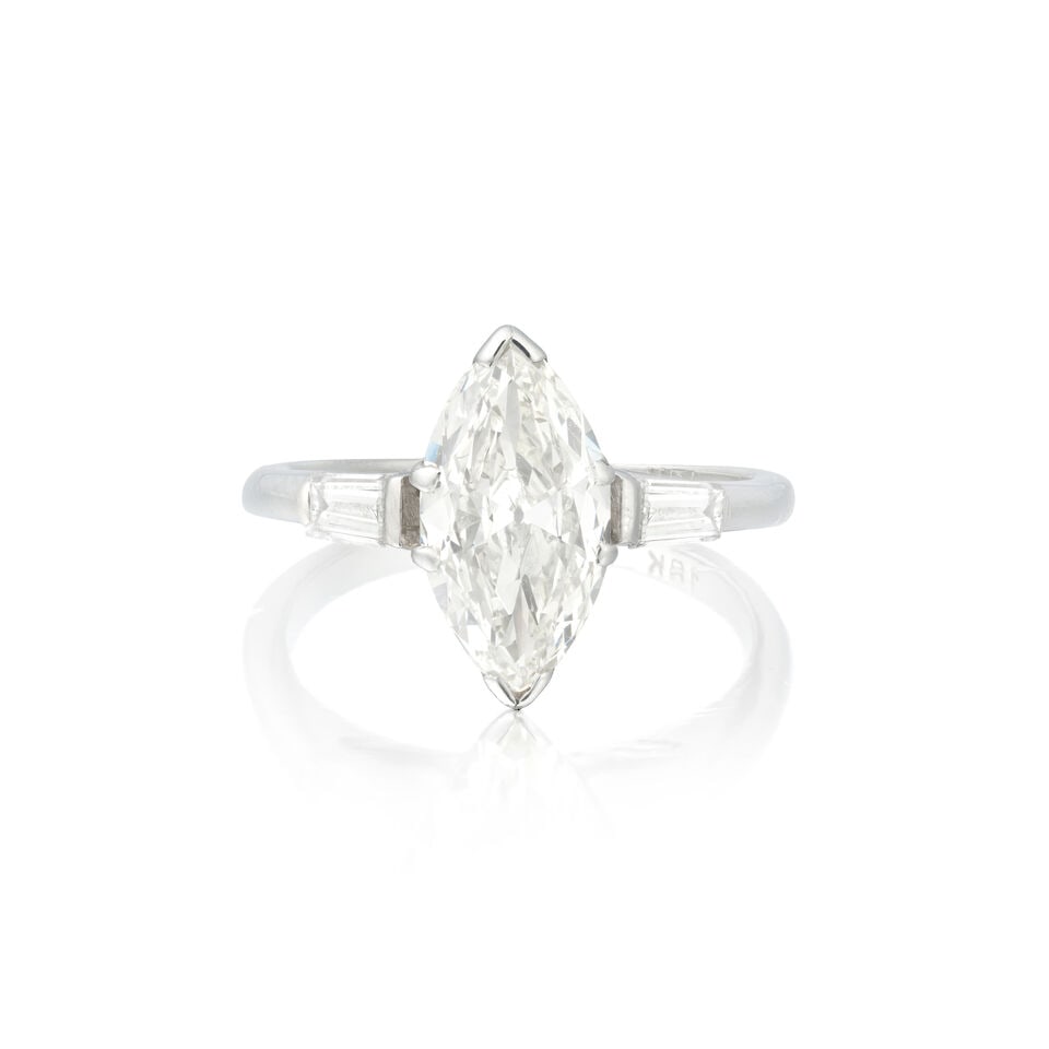 DIAMOND RING: DIAMOND RING Marquise-cut diamond weighing 1.31 carats Tapered baguette-cut diamonds Ring size approx. I Weight approx. 2.5g Footnotes: OVERALL CONDITION Light surface wear to unhallmarked white