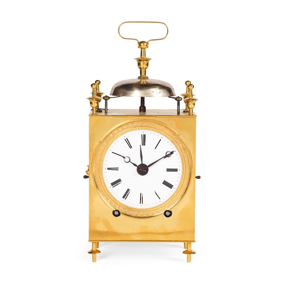 Pendule de voyage Capucine en laiton, France début du XIXe siècle An early 19th centur...: Pendule de voyage Capucine en laiton, France début du XIXe siècle An early 19th century French brass Capucine travelling clock Of typical form with bell and flattened handle framed by