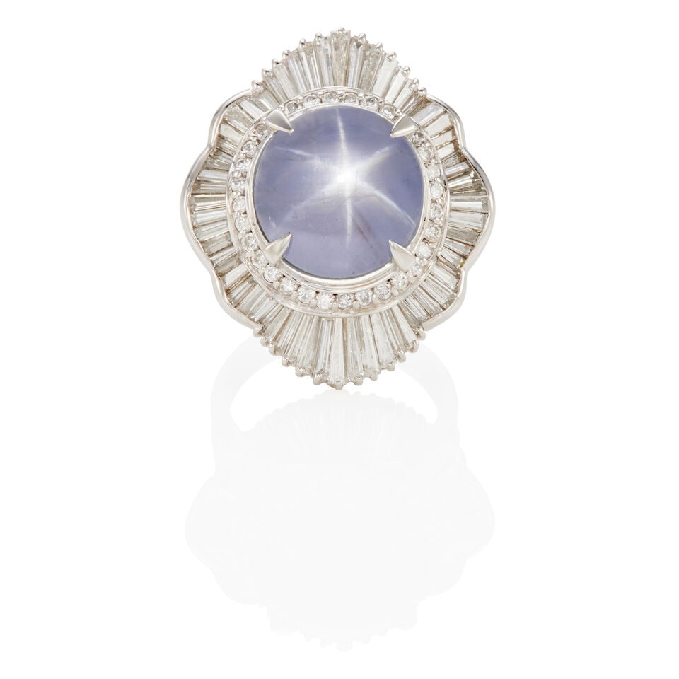 PLATINUM, STAR SAPPHIRE AND DIAMOND RING: PLATINUM, STAR SAPPHIRE AND DIAMOND RING • Platinum • Numerous round and tapered baguette diamonds weighing approximately 1.80- 2.00 carats total • 1 round cabochon star sapphire