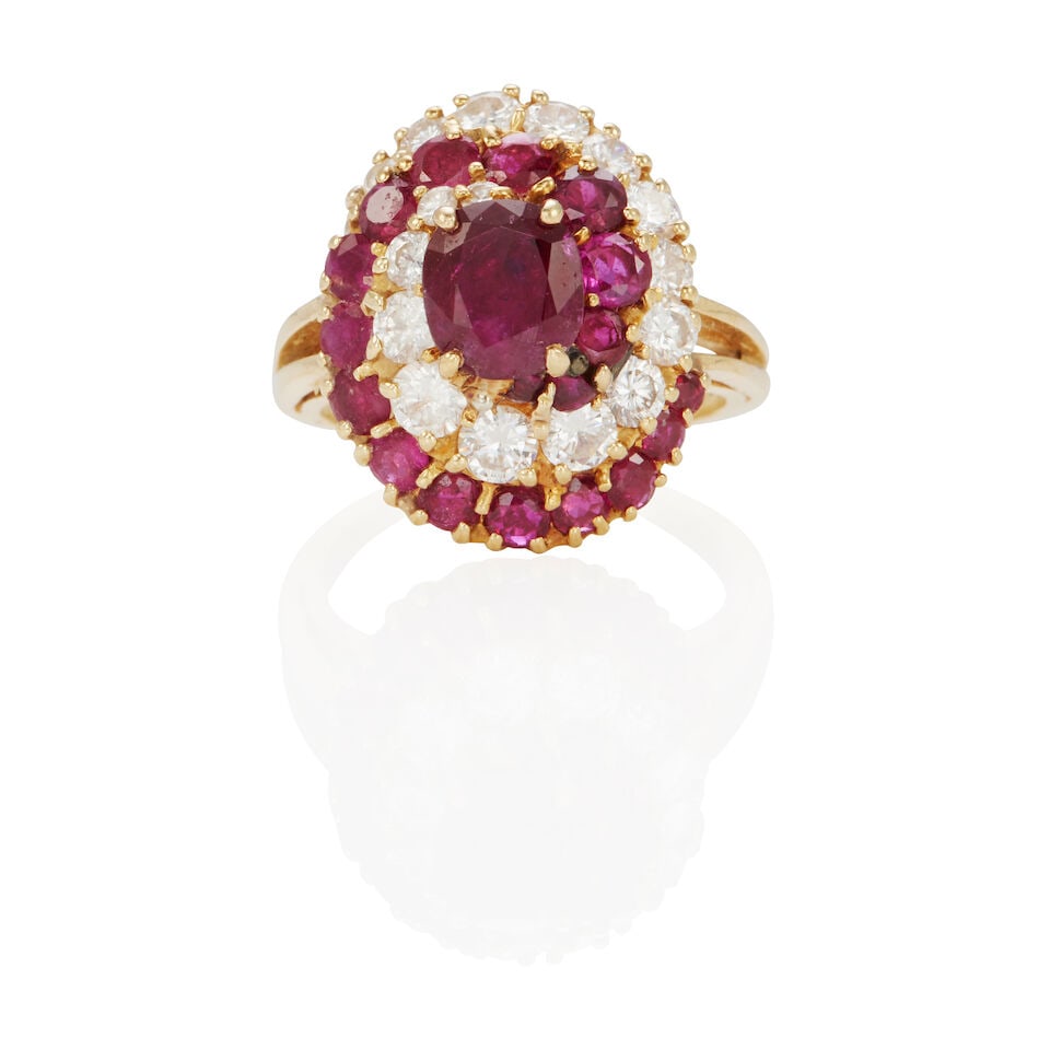 18K GOLD, RUBY AND DIAMOND RING: 18K GOLD, RUBY AND DIAMOND RING • 18k yellow gold • 1 oval ruby weighing approximately 1.45 carats (7.1 x 6.2 x 4.15 mm) • Numerous round rubies measuring 1.8 - 2.95 mm • Numer