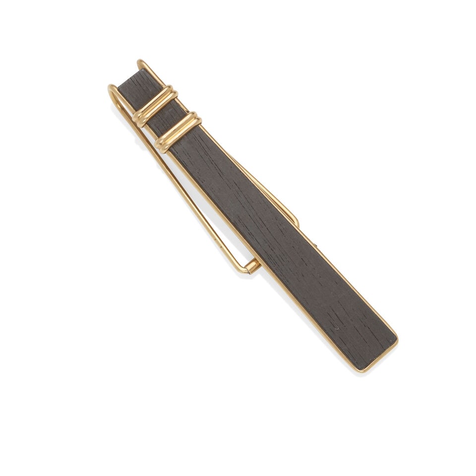 ALLAN ADLER: 14K GOLD AND EBONY TIE CLIP: ALLAN ADLER: 14K GOLD AND EBONY TIE CLIP • 14k yellow gold • 1 piece of ebony wood • Signed 'ALLAN ADLER' and numbered, stamped 'HANDMADE' • Measures 2 ¾ x ⅜