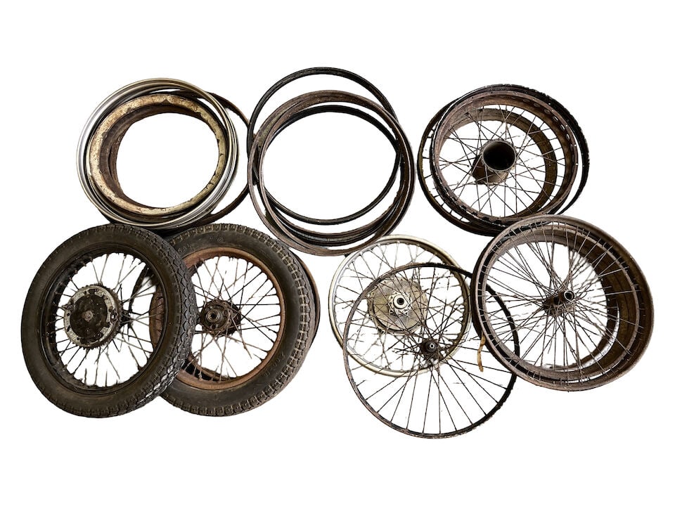 A large quantity of motorcycle wheels, wheel rims and belt rims: A large quantity of motorcycle wheels, wheel rims and belt rims Including Vintage and later examples; together with cyclemaster spares. Condition and completeness unknown. Prospective bidders must sat