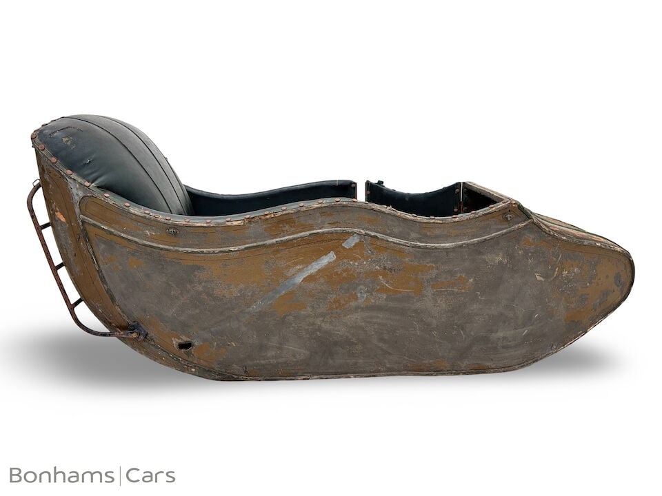 A Mills & Fulford Sidecar body ((2)): A Mills & Fulford Sidecar body in believed original condition together with a belt drive wheel, close inspection advised. (2) Footnotes: BUYER'S PREMIUM The Buyer's Premium for this Lot is 28%+VAT on 